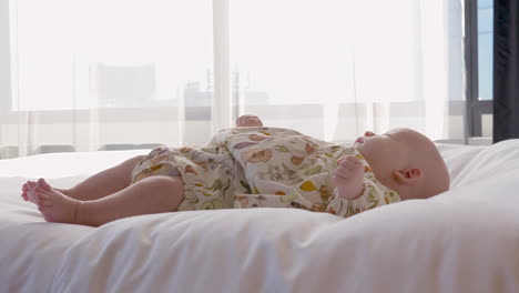 Baby-girl-lying-on-the-bed-at-home