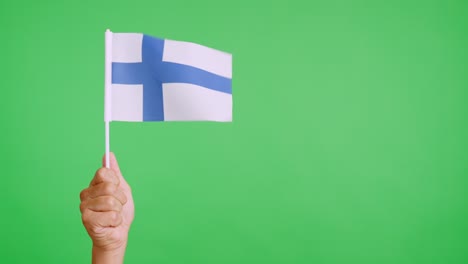 wind waving a finnish pennant holding by a hand