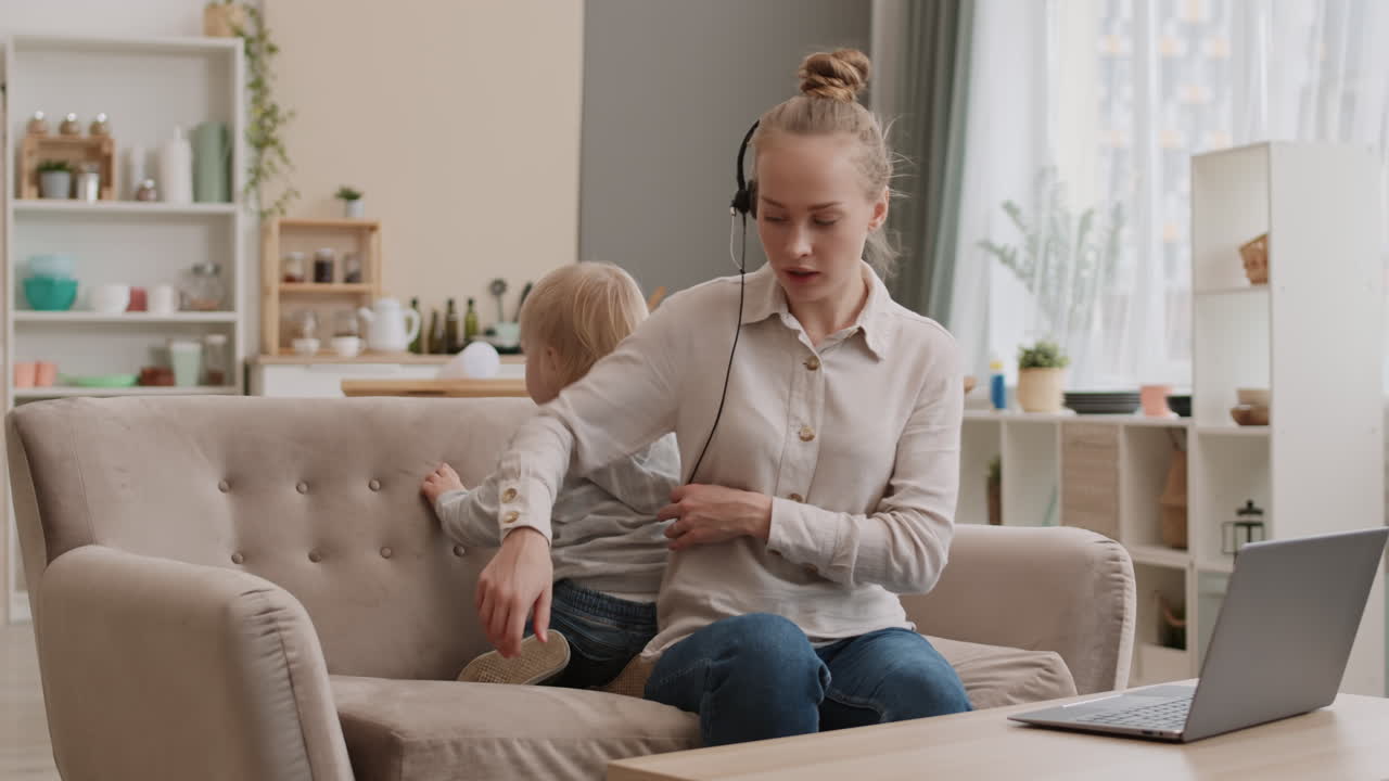 Woman Distracted from Work by Toddler