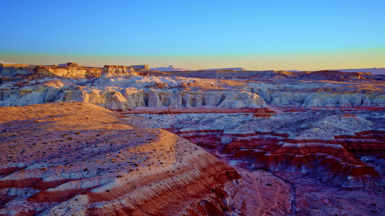 Drone camera pans across desert hoodoos with eye-catching rock striations and earth tones.