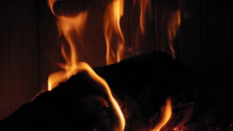 burning flame at fireplace on wooden logs