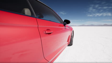 red car on a salt flat