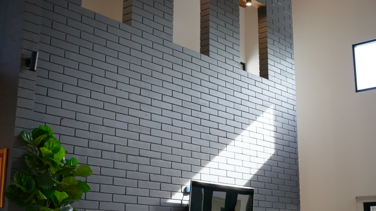Grey brick feature wall with window cutouts
