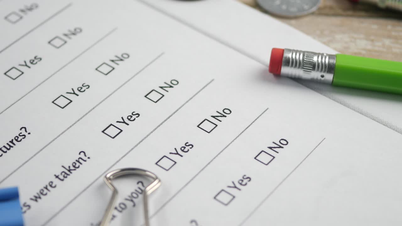 Hand Checking Yes Box on a Survey Form with a Pencil