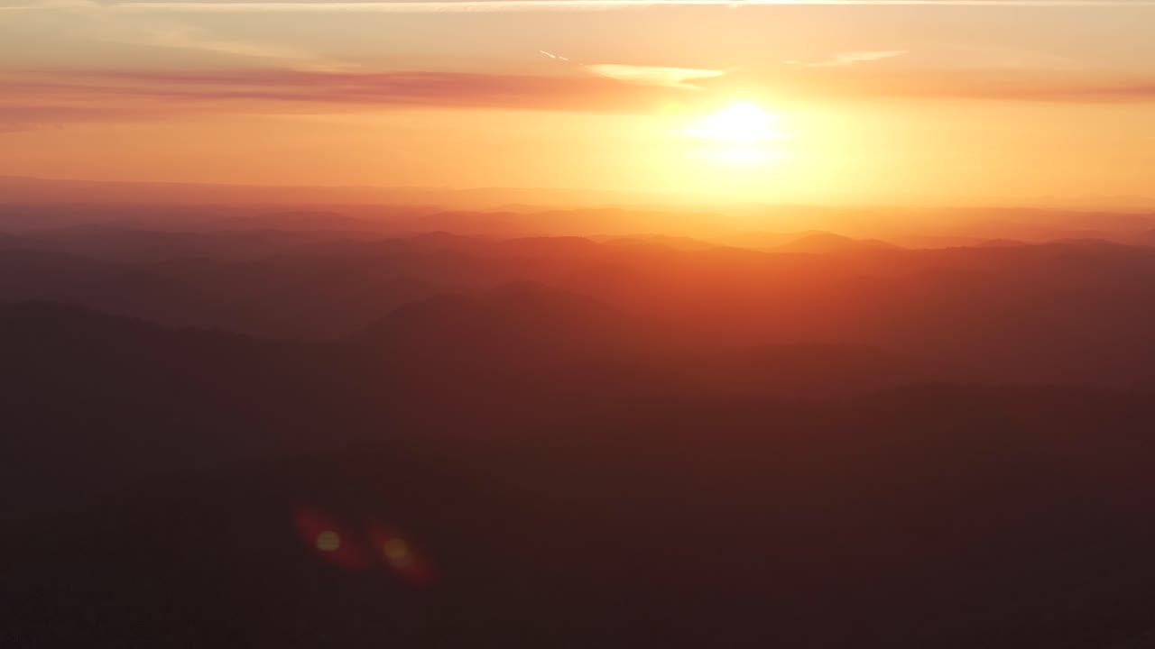 Outback orange yellow vibrant sunset sunrise on mountain layers horizon golden hour Lower Mangrove Hawkesbury River Creek NSW Sydney Blue Mountains Australia aerial drone Spring Summer circle right
