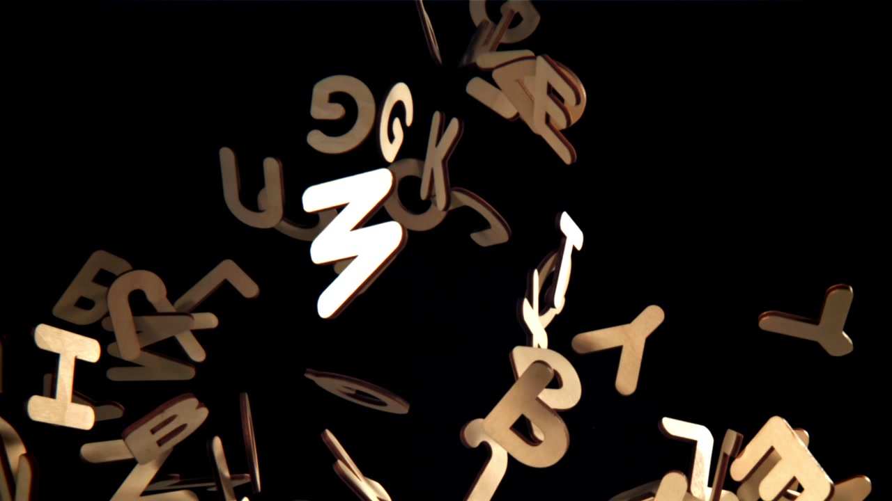 Wooden Alphabet Letters Floating Upwards on Black Background