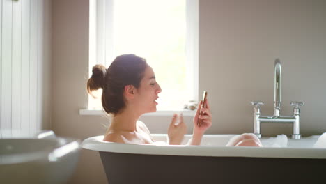 A-happy-woman-blowing-a-kiss-during-a-video-call