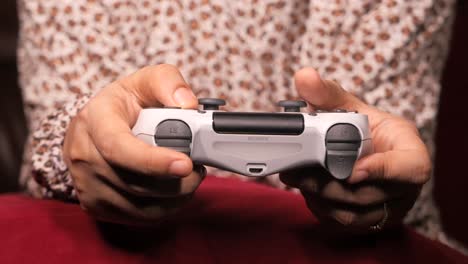 person playing video game with playstation controller