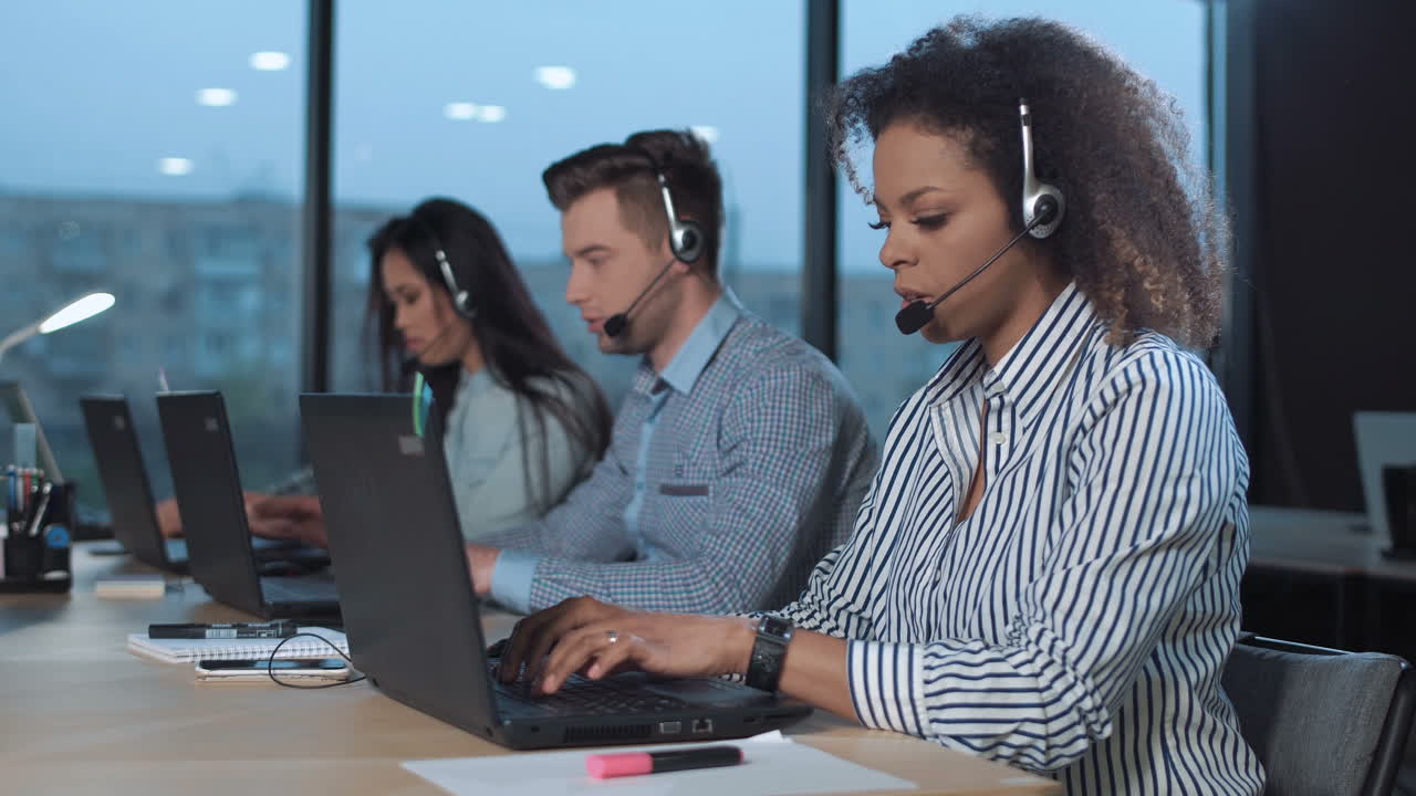 Call Center Agents Working on Laptops