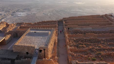 ancient masada fortress ruins and terraces at sunset