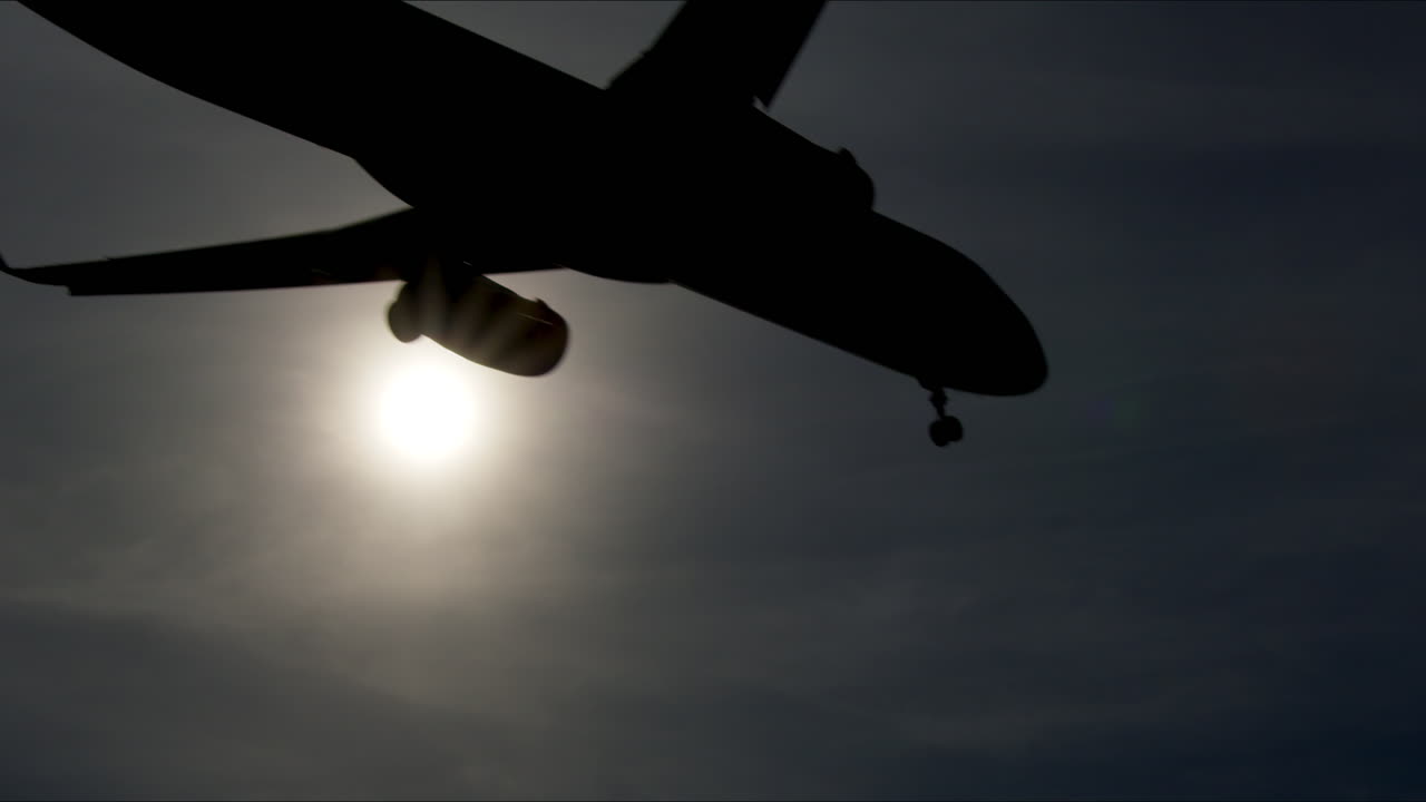 Airplane Silhouette Against Cloudy Sky