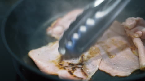 Rohe-Schinkenscheiben,-Die-In-Einer-Schwarzen-Pfanne-Kochen