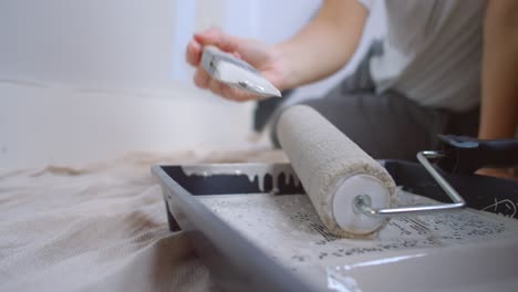 woman painting wall in home