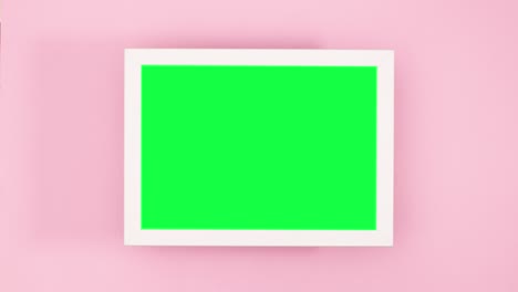 marco con adornos de navidad de oro y estrellas y pantalla verde en tema rosa pastel. stop motion