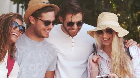 Smiling-hipster-friends-looking-at-smartphone
