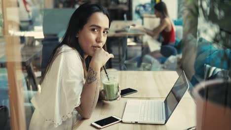 Serious-young-woman-working-at-a-laptop-computer