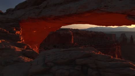 pandown of mesa arch to reveal and frame distant mountains inside canyonlands national park