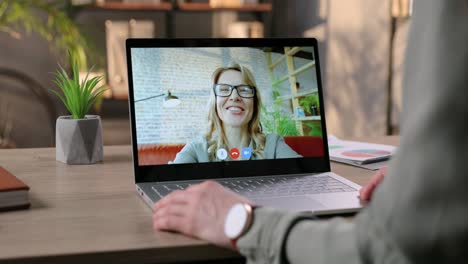 Female-Speaking-On-Video-Conference-On-Laptop-With-Cheerful-Woman-In-Room