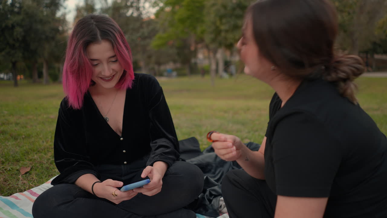 Two Women Friends Having a Conversation in a Park