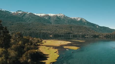 drone moves above the river to see the autumn landscape with the lake in the background