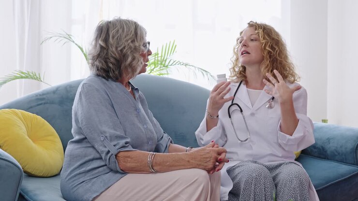 Doctor consulting with elderly patient at home