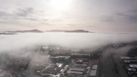 wide panning aerial dolly shot of hills rising above fog along highway 101 in santa rosa, california. 4k