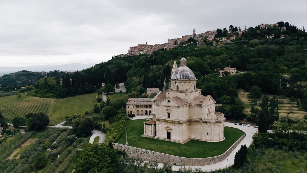 Aerial view pushing towards Sanctuary of the Madonna di San Biagio in Italy's rural countryside