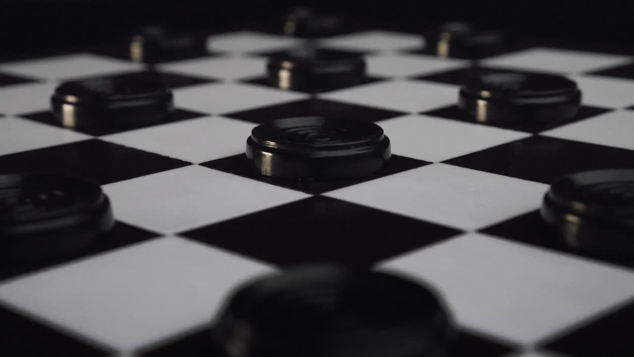 Checkers black pieces coming back to their positions on the checkerboard SLOW MOTION REVERSE SHOT (Draughts)