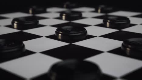 checkers black pieces coming back to their positions on the checkerboard slow motion reverse shot (draughts)