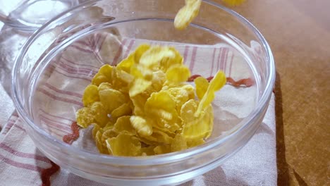 Crispy-yellow-corn-flakes-into-the-bowl-for-the-morning-a-delicious-Breakfast-with-milk.-Slow-motion-with-rotation-tracking-shot.