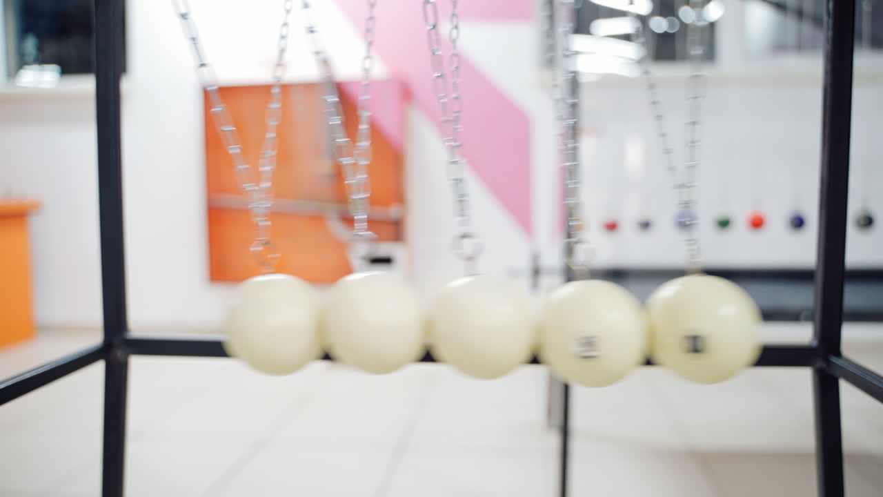 Newton's cradle showing laws of physics in motion. Museum of Science