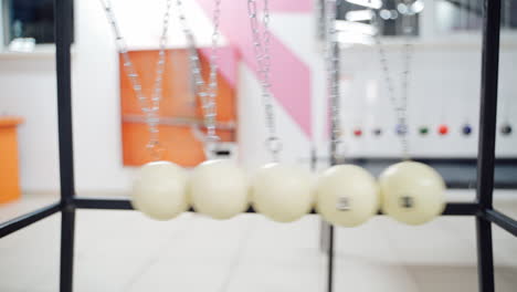 newton's cradle showing laws of physics in motion. museum of science