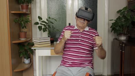 senior grandfather in virtual headset glasses watching video in 3d vr helmet and dancing, having fun