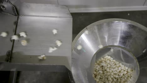 shot of a popcorn falling in a bag from a conveyor