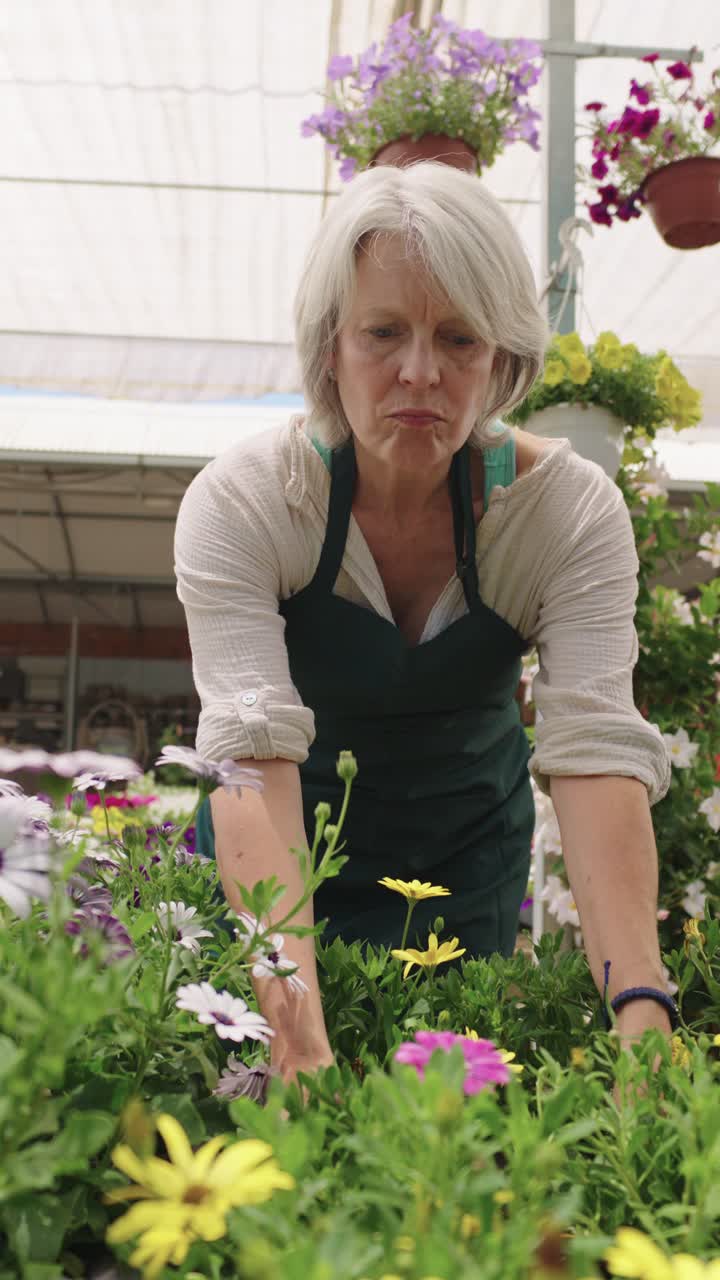 Woman working with flowers in a greenhouse