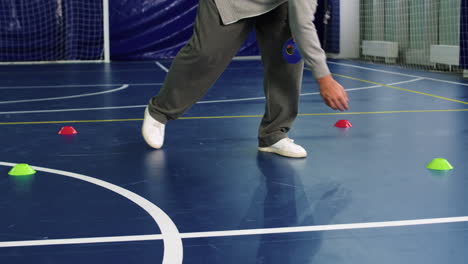 man putting objects on the floor