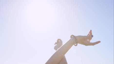 beautiful woman enjoying ride in convertible vintage car on road trip with outstretched arms