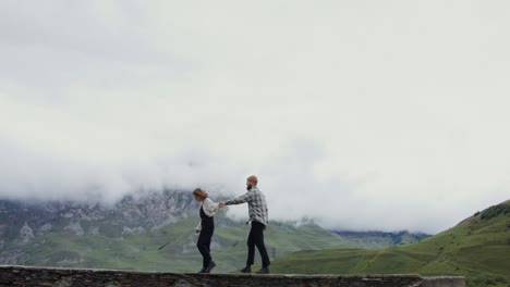 couple walking through mountains