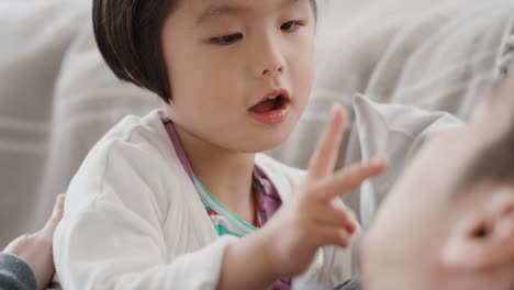 beautiful-little-asian-girl-with-father-having-family-time-dad-playing-with-daughter-at-home-4k