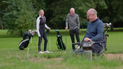 golfers playing golf with golf carts