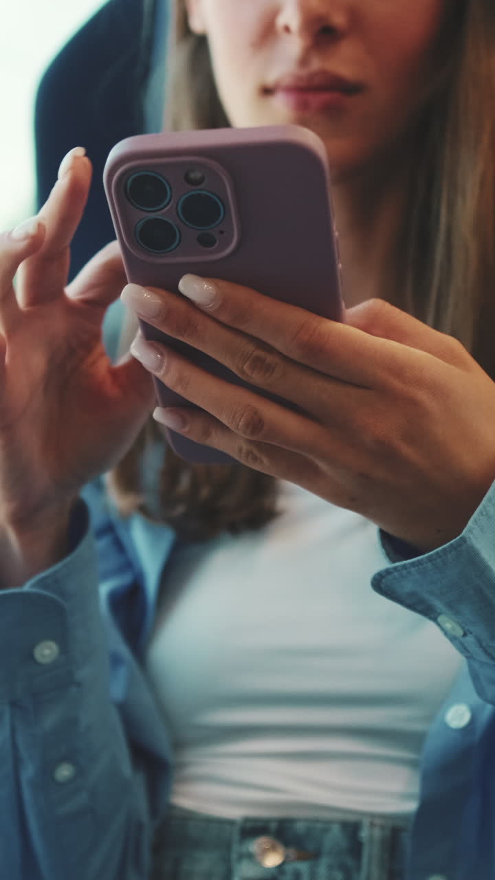 Close-up of Young Woman's Hands Using a Smartphone