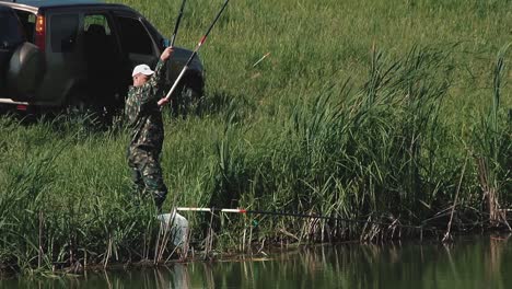 fisherman pulls out the fishing rod with the fish