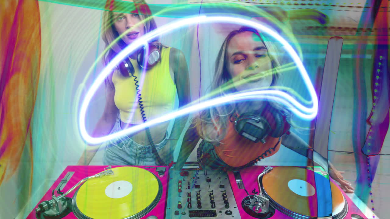 djs gemelas idénticas bailando detrás de tocadiscos y luces de discoteca