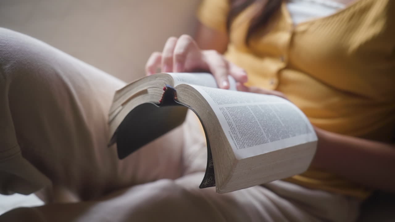 Unrecognizable Woman Reading Bible At Home. Closeup