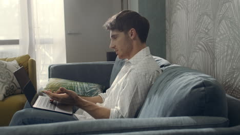 attractive guy having video call laptop. man using computer for video conference