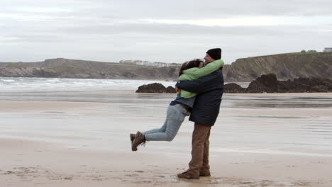an indian couple having fun on porthtowan beach in cornwall, england, the uk