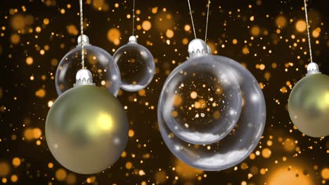 animation of christmas baubles dangling with snow falling on black background