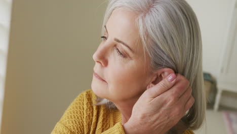 Senior-caucasian-woman-touching-her-hair-and-thinking