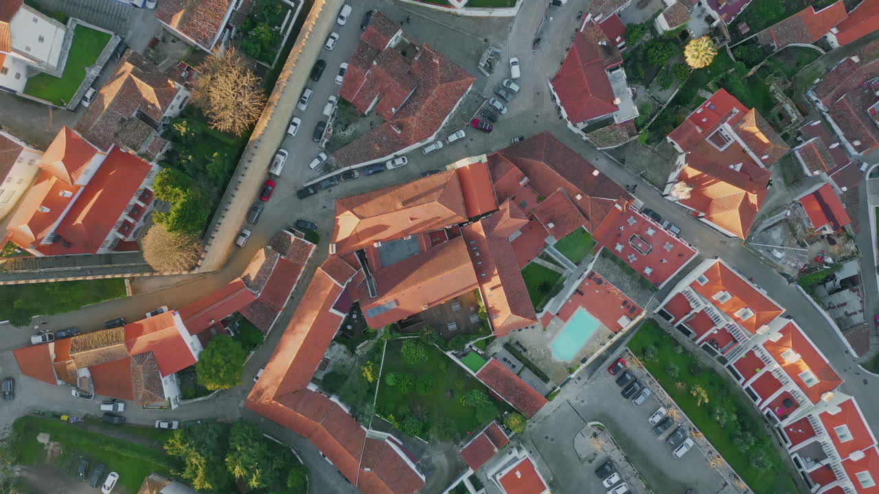 Top town red rooftops at evening sunlight. Urban streets and residential area