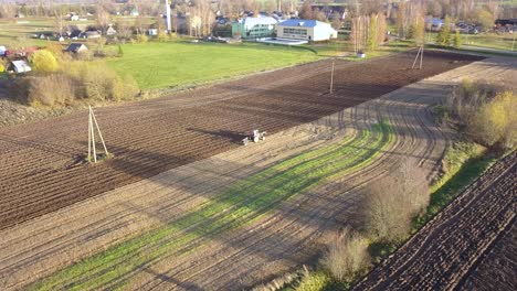 farmer plowing land on farm for crop planting